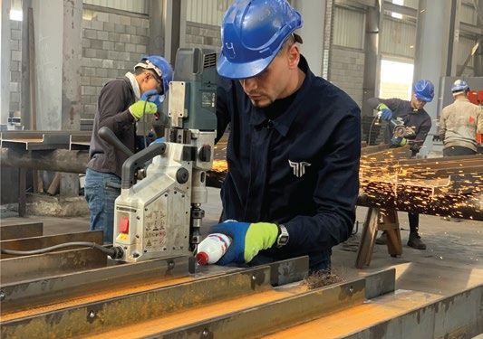 Technician operating CNC drilling equipment